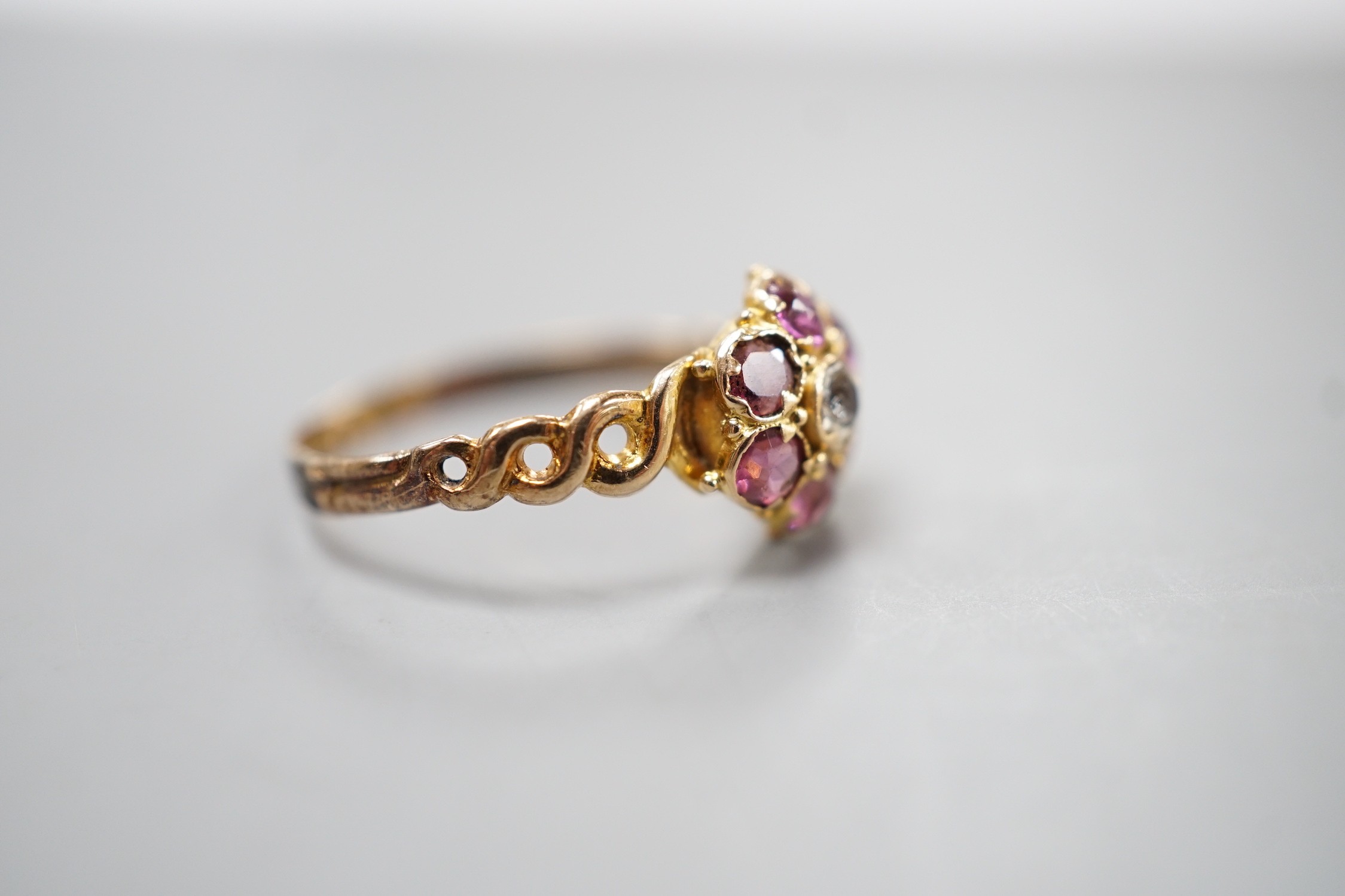 A late Victorian 15ct gold amethyst and quartz? cluster set dress ring, size P, gross weight 1.3 grams, with pierced ring shoulders.